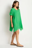 Woman wearing the Sea Level Sunset Kaftan - Kelly Green against a white background