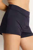 Navy blue shorts worn by a person on a plain background
