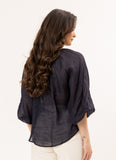 Woman wearing a dark blue Leila + Luca Jade Top - Ink kimono-style top on a white background