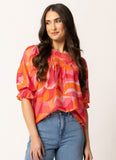Woman wearing the Seeking Lola Noble Top - Tropical Punch