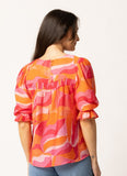 Woman wearing the Seeking Lola Noble Top - Tropical Punch
