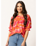 Woman wearing the Seeking Lola Noble Top - Tropical Punch