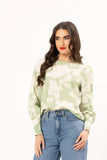Seeking Lola Charlie Top - Poetic Leaf Woman wearing a green tie-dye shirt and blue jeans on a white background