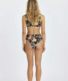Person wearing a floral bikini set on a white background
