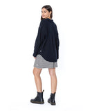 Woman wearing a navy blue cardigan over a striped dress on a white background Sisstrevolution South Beach Woven LS Top - Black