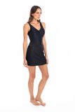 A woman modeling a black sleeveless wrap-style mini dress against a plain white studio background.