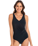 A model wearing a black one-piece swimsuit with a surplice neckline and ruching design.