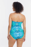 A woman shown from the back wearing a strapless one-piece swimsuit with a blue and turquoise tie-dye pattern, set against a plain white studio background.