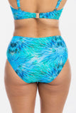 Rear view of a model wearing a two-piece bikini with a vibrant blue and turquoise abstract pattern, featuring a high-waisted bottom and matching bikini top.