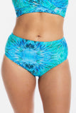 A close-up of a model wearing a two-piece bikini with a vibrant blue and turquoise tie-dye pattern, set against a plain white background.