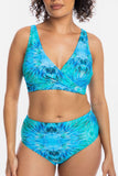 A woman modeling a two-piece bikini set with a vibrant blue and turquoise tie-dye pattern against a plain white background.