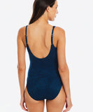 Woman wearing a blue swimsuit on a white background TOGS Amalfi V Neck Plunge One Piece
