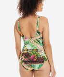 Woman wearing a colorful patterned swimsuit on a white background