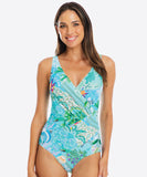Woman wearing a colorful one-piece swimsuit on a white background