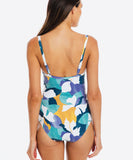 Woman wearing a colorful patterned swimsuit on a white background