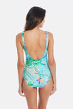 A woman shown from the back wearing a one-piece swimsuit with a vibrant tropical and paisley print in shades of turquoise, green, and blue, set against a plain white background. TOGS Peru Lucca Reversible Square One Piece