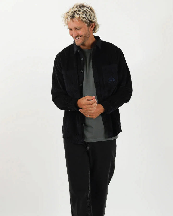 Man wearing a black shirt and pants on a white background T&C Motion LS Cord Shirt - Midnight