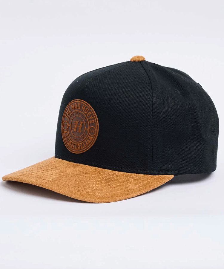 Black and brown cap with a logo on a white background The Mad Hueys Hueys Suede Hueys Twill Snapback - Black