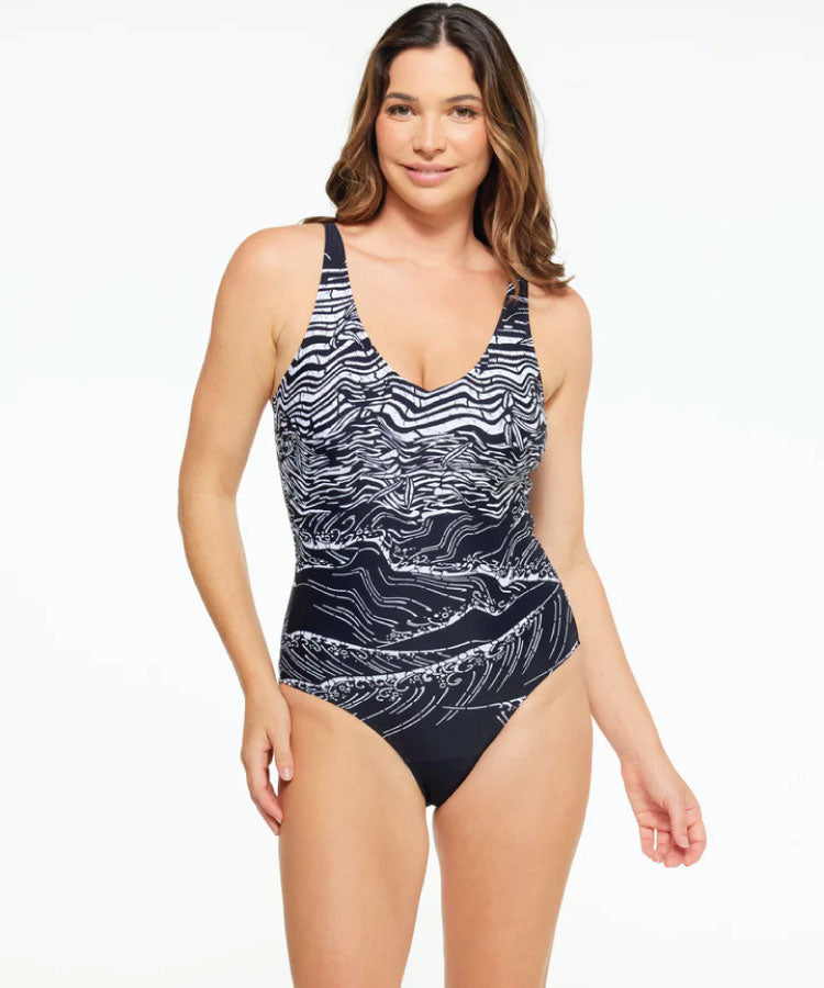 A model wearing a v-neck plunge one-piece swimsuit with a geometric pattern in black and white. Togs - Budapest V Neck Plunge One Piece Swimsuit