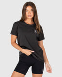 Woman wearing a black t-shirt and shorts with a logo on a white background