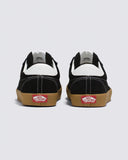 Vans Sport Low Black/Gum Black and white sneakers with brown soles on a light gray background