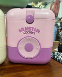 A pink and purple Vanstar coolers portable cooler with a circular control dial, shown on a wooden surface with other coolers in the background.