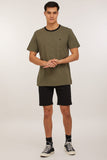 Front view of the model wearing the Volcom Solver shorts in black.