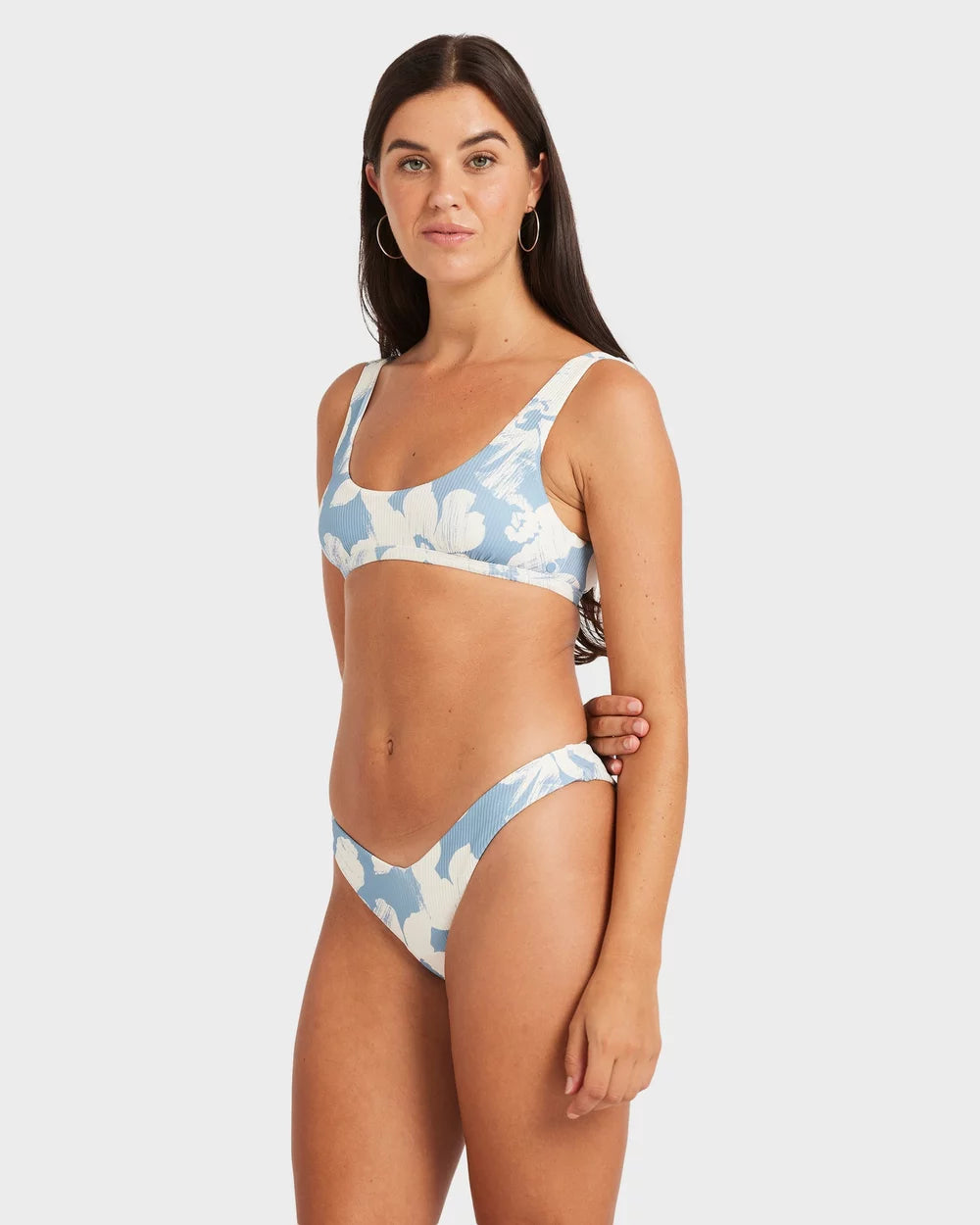 Woman wearing a blue and white patterned bikini on a white background Volcom Make Us Shine Tank Bikini Top - Bay Blue