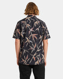 Person wearing a dark patterned shirt with leaf design on a white background Volcom Scaler Stone Woven SS Shirt - Vintage Black