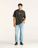 Man wearing a black Wrangler t-shirt and light blue jeans on a white background