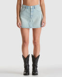 Light blue denim skirt worn by a person on a white background