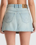 Light blue denim skirt worn by a person on a white background