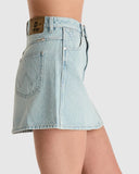 Light blue denim skirt worn by a person on a white background