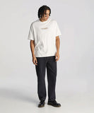 A person standing wearing a white T-shirt and black baggy fit jeans with a vintage finish.