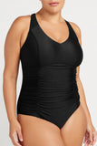 Black one-piece swimsuit worn by a model on a white background showing tummy control panels and special features of this swimsuit.
