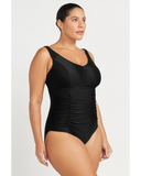 Woman wearing a black swimsuit against a white background