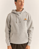 A man wearing a light gray heather pullover hoodie with a small embroidered 'RHYTHM' sun logo on the left chest, photographed against a plain light beige studio background. Rhythm Mens Awake Fleece Hood - Grey Heather