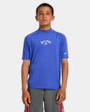 Billabong Boys All Day Arch UPF 50 Rashguard in Cobalt blue front view showing the comfortable crew neck layout long sleeves and iconic clean arch brand logo screen print, sold by Point Break Cambridge local family surf shop at 63 Duke street.