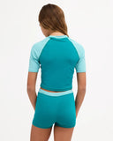 Billabong Girls Billa Star Rash Guard Set in Evergreen back view highlighting the coordinated two-piece swimwear silhouette comfortable rash guard coverage flexible swim fabric construction and distinctive Evergreen colourway, sold by Point Break Cambridge local family surf shop at 63 Duke Street.