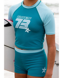 Billabong Girls Billa Star Rash Guard Set in Evergreen front view showcasing the stylish two-piece girls swimwear design comfortable rash guard top coordinating swim bottoms and fresh coastal-inspired colourway, sold by Point Break Cambridge local family surf shop at 63 Duke Street.