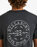 Billabong Mens Big Wave Daz T-Shirt in Black close up view highlighting the premium soft cotton knit fabric weave texture and high density screen print graphic finish detail, sold by Point Break Cambridge local family surf shop at 63 Duke street.