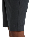Billabong Mens Crossfire Hybrid Walkshorts in Asphalt close up view highlighting the premium recycled polyester four-way stretch fabric texture Micro Repel quick-dry finish internal jacquard waistband detailed stitching and signature Billabong wave label, sold by Point Break Cambridge local family surf shop at 63 Duke Street.