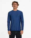 Billabong Mens Shoreline UPF 50 Long Sleeve Rashguard in Denim Heather blue front view showing the comfortable crew neck long sleeve sun protection layout and clean chest brand graphic logo print, sold by Point Break Cambridge local family surf shop at 63 Duke street.