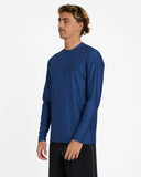 Billabong Mens Shoreline UPF 50 Long Sleeve Rashguard in Denim Heather blue side profile view showing the comfortable regular sleeve length extension and clean anti chafe underarm panel architecture alignment, sold by Point Break Cambridge local family surf shop at 63 Duke street.