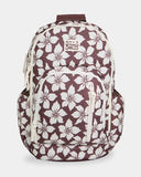 Billabong Playa Sol Roadie Backpack in Teak front view showcasing the distinctive chocolate and neutral tropical floral print spacious 31-litre silhouette vertical zippered front pocket durable recycled polyester fabric and signature Billabong flower rubber logo, sold by Point Break Cambridge local family surf shop at 63 Duke Street.