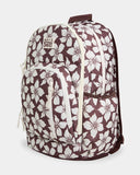 Billabong Playa Sol Roadie Backpack in Teak side profile view showcasing the spacious 31-litre storage capacity elasticated side water bottle pockets multiple zippered compartments and distinctive chocolate-toned tropical floral print, sold by Point Break Cambridge local family surf shop at 63 Duke Street.