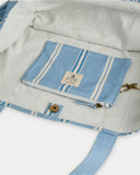 Billabong Salt Air Stripe Tote Bag in Powder Blue close up view highlighting the premium 100% cotton canvas fabric texture vintage-washed stripe print quality stitching signature Billabong woven logo patch and detachable interior storage pouch, sold by Point Break Cambridge local family surf shop at 63 Duke Street.