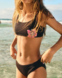 Billabong Waterlily Bralette Set in Black Pebble front view showcasing the stylish two-piece girls bikini design banded bralette top adjustable tie straps coordinating full-coverage swim bottoms and distinctive Billabong chest print detailing, sold by Point Break Cambridge local family surf shop at 63 Duke Street.