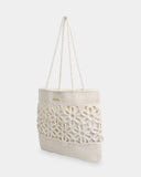 Billabong Wild Daisies Tote Bag in Salt Crystal side profile view showcasing the roomy tote bag silhouette comfortable crochet cord shoulder straps flexible construction and distinctive floral crochet design for everyday beach and summer adventures, sold by Point Break Cambridge local family surf shop at 63 Duke Street.