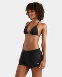 Billabong Womens Legacy Boardshorts in Black side profile view highlighting the modern performance leg outseam rise clean scalloped hemline tracking and iconic woven brand logo patch detailing, sold by Point Break Cambridge local family surf shop at 63 Duke street.